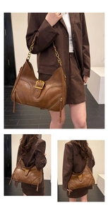Detail of vintage brown shoulder bag with gold hardware and chain strap accents