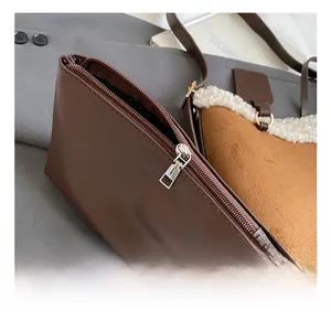 Close-up of a deep brown faux leather pouch featuring a premium silver metal zipper detail