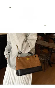 Detail of brown and black quilted chain bag featuring a gold twist lock and matte finish