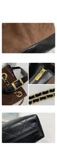 Detail view of quilted leather texture and golden metal chain strap on tote bag