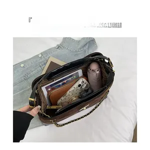 Spacious tote bag with quilted chain strap showing tablet, wallet, and umbrella inside