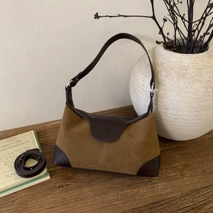 Dettaglio della combinazione di pelle scamosciata e liscia in una borsa a tracolla vintage