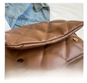 Detail view of the caramel quilted leather bag featuring a strong magnetic closure