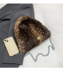 Brown leopard print plush bucket bag with gold ball clasp and silver chain detail