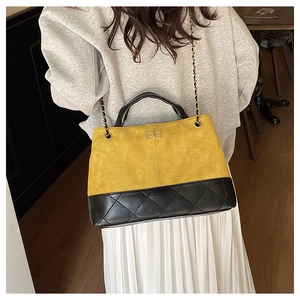 Close-up of diamond-quilted chain bag featuring contrast matte yellow and black textures