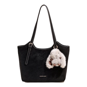 Black matte leather tote bag with white stitching and plush bunny pendant for women