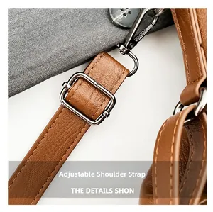 Close-up of brown leather adjustable shoulder strap with durable silver metal buckle