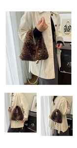 Detailed view of plush leopard print handbag with golden bead charm and silver chain strap