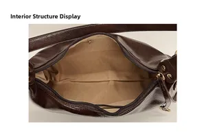 Structure interne du sac à bandoulière en cuir marron foncé avec doublure beige et zip