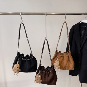 Quilted suede bucket bags with chain straps and plush bear charms in three colors