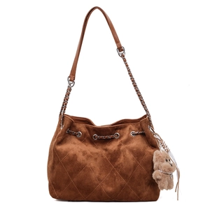 Brown quilted suede bucket bag with chain strap and plush bear charm for women