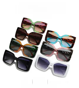Detailed view of square oversized sunglasses in tortoise, green, and classic black tones