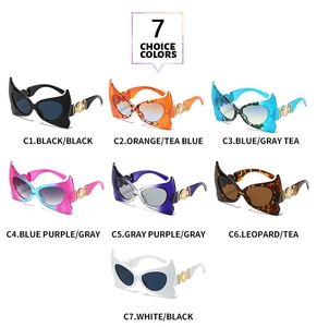 Detail of bat-wing sunglasses with gold disc accents and various color lens options