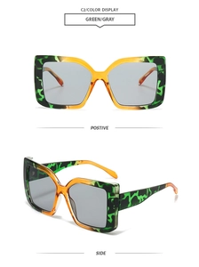Detail view of square leopard print sunglasses in green and yellow with grey lenses