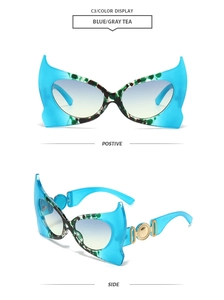 Detail of bat-wing sunglasses with blue marble frames and gold embossed side temples