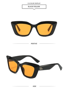 Détail de lunettes de soleil œil-de-chat avec monture noire et verres orange vif