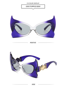 Detail of bat-wing sunglasses featuring golden coin hinges and gradient purple frames