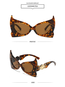 Close-up of leopard print bat-wing sunglasses featuring golden metal accents and tea lenses