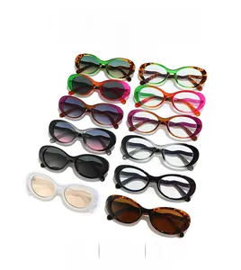Flat lay of retro oval sunglasses in multiple colors with wave temples on white backdrop
