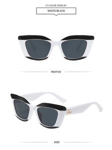 Détail de lunettes de soleil œil-de-chat avec monture bicolore et logo doré