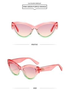 Detail of cat-eye sunglasses with pink-green gradient frame and purple-orange lenses