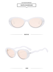 Detail view of oval sunglasses with creamy white frames and wavy temples