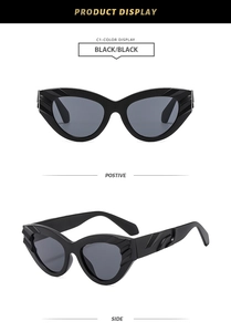 Detail of vintage cat eye sunglasses with textured frames and smoke grey lenses