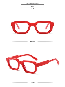 Detail view of bold red geometric thick-frame glasses showing front and side profile