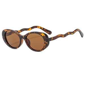 Retro oval sunglasses with tortoise frame, brown lenses, and stylish wavy temples