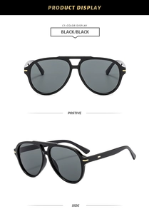 Detail view of black aviator sunglasses with gold metal accents and double bridge