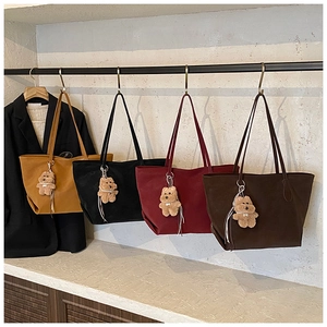 Four large capacity faux suede tote bags in various colors with cute bear charms