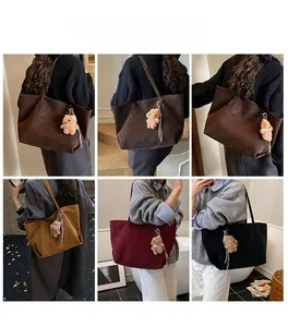 Detail view of large tote bags in four colors with cute plush bear charms on shoulder straps