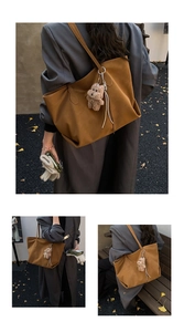 Caramel tote bag with plush dog charm worn over the shoulder during autumn commute