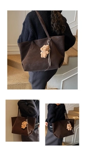 Detail of a large dark brown leather tote bag with a cute brown plush bear charm