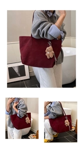 Detail of burgundy suede tote bag with a cute plush bear pendant and large capacity design