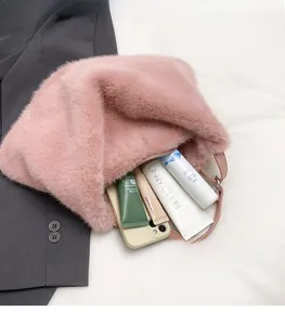 Detail view of pink plush crossbody bag interior showing spacious capacity for cosmetics