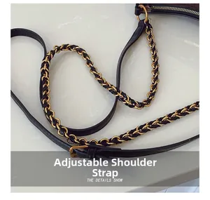 Detail of adjustable shoulder strap with gold chain and black leather weaving