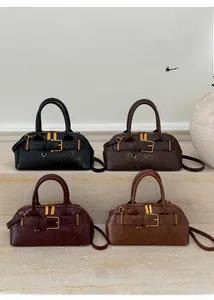 Boston handbags in black, coffee, burgundy and tan displayed on a stone steps background