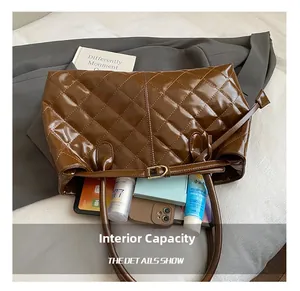 Internal capacity of brown quilted tote bag showing space for phone and cosmetics