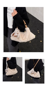 Detail of off-white plush faux fur handbag with brown leather strap and bunny charm
