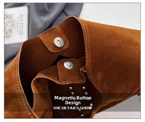 Detail of the magnetic closure and rivet accents on the brown suede tote bag