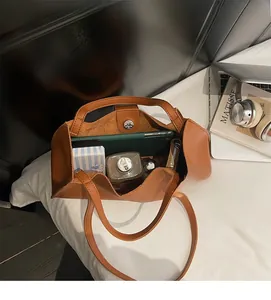 Macro view of caramel tote bag interior showing spacious capacity and magnetic buckle