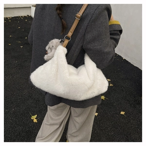 Detailed back view of a white plush shoulder bag with brown leather strap and elephant charm