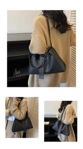 Macro detail of minimalist black tote bag with premium lychee grain leather texture