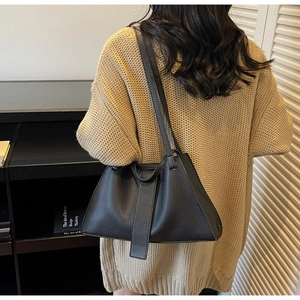 Litchi texture black leather shoulder bag shown on model for daily commuting style