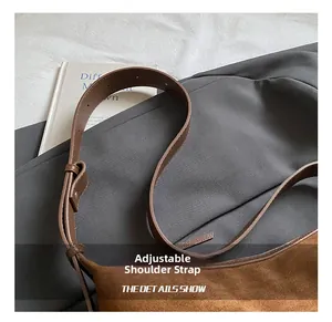 Détail du sac hobo en daim marron avec bandoulière réglable en cuir de même couleur