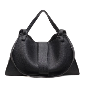 Close-up of black grainy leather texture and buckle detail on minimalist hobo bag