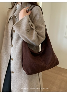 Detail view of the vintage dark brown suede tote bag with minimalist stitching and soft texture