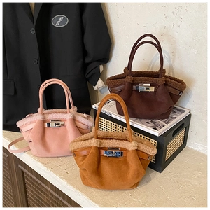 Detail of suede bucket bags with plush trim and silver twist locks in three colors