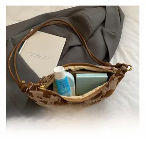 Detail view of crescent bag interior showing capacity for cosmetics and daily essentials